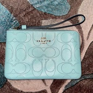 Coach wristlet light blue out - dark blue inside. 2 credit card slots. Zip top